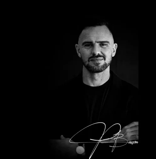 Jason B. Monochrome portrait with signature.